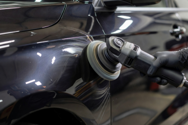 Close-up of real vehicle paintwork being polished with a professional polishing machine