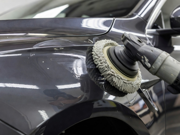 Professional paint polishing pad working on real automotive clear coat during paint care